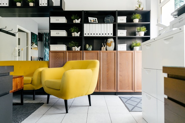 Bright yellow chair in front of nice storage cabinets