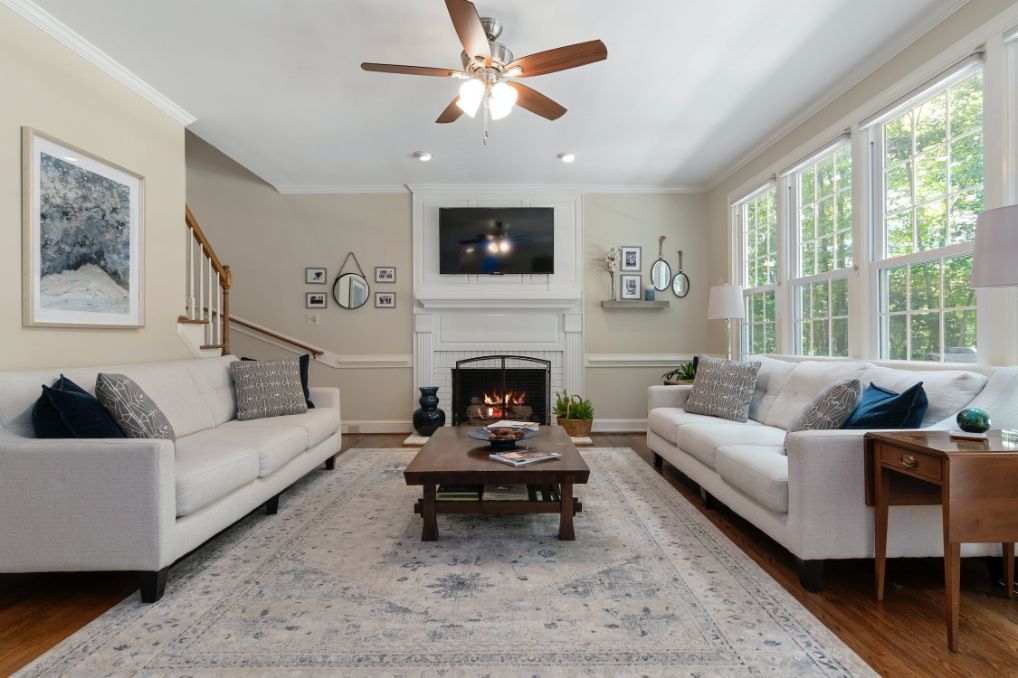 White living room couches with brick fireplace